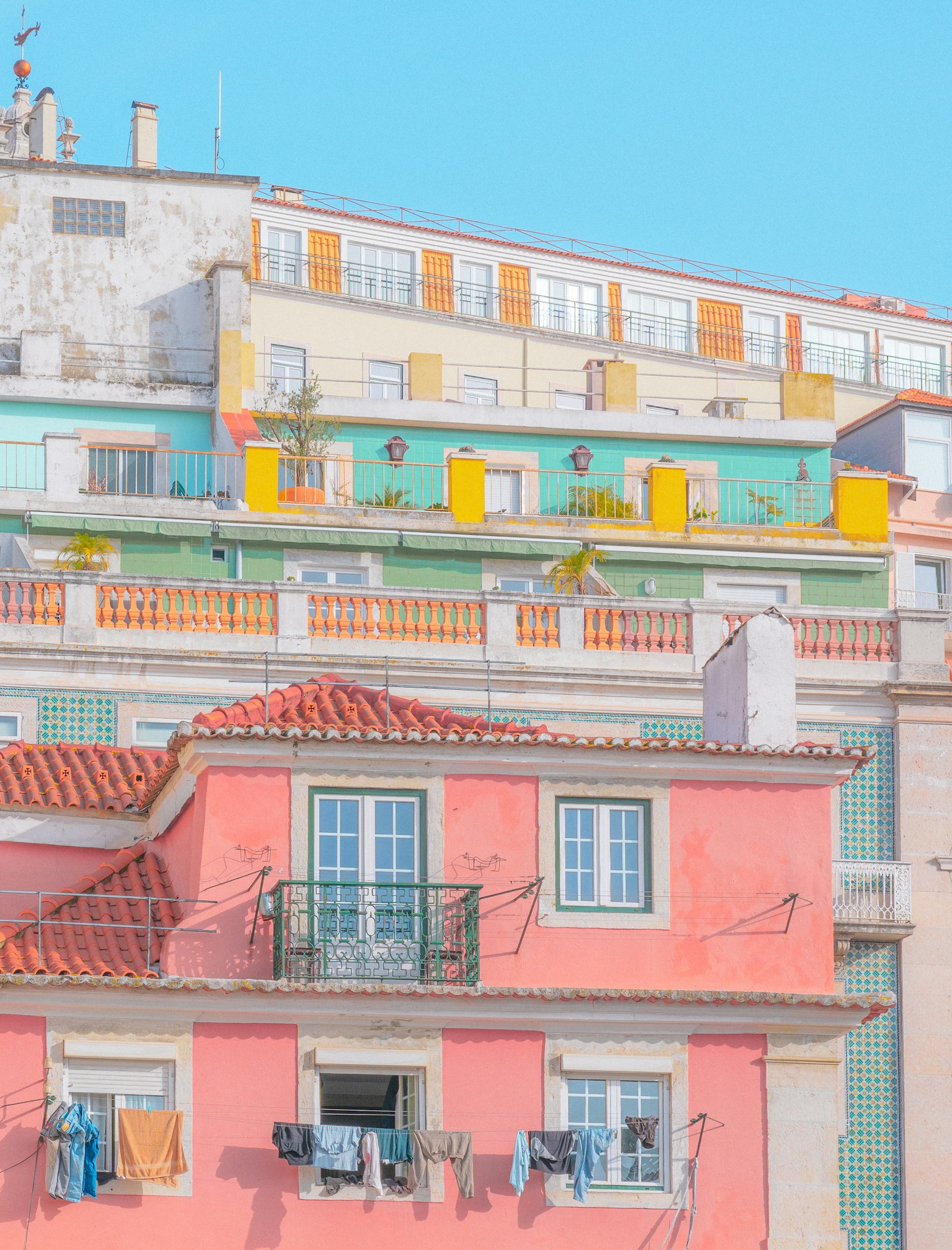 Pastel hillside houses and a tiled rooftop in coastal Portugal